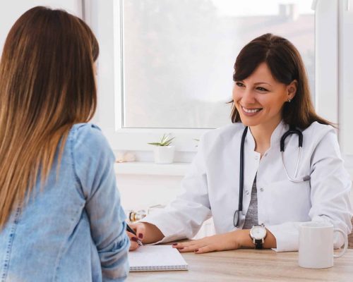 Patient,Having,Consultation,With,Female,Doctor,In,Office Patient Having Consultation With Female Doctor In Office